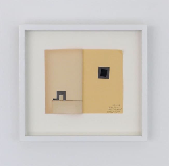 Bureau with photo frame book and painting on cracked wall